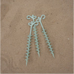 Alloy sand peg on coastal campsite